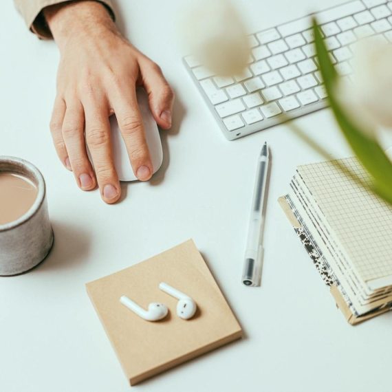 Stylish workspace with coffee, notebook, keyboard, and pen for productivity.